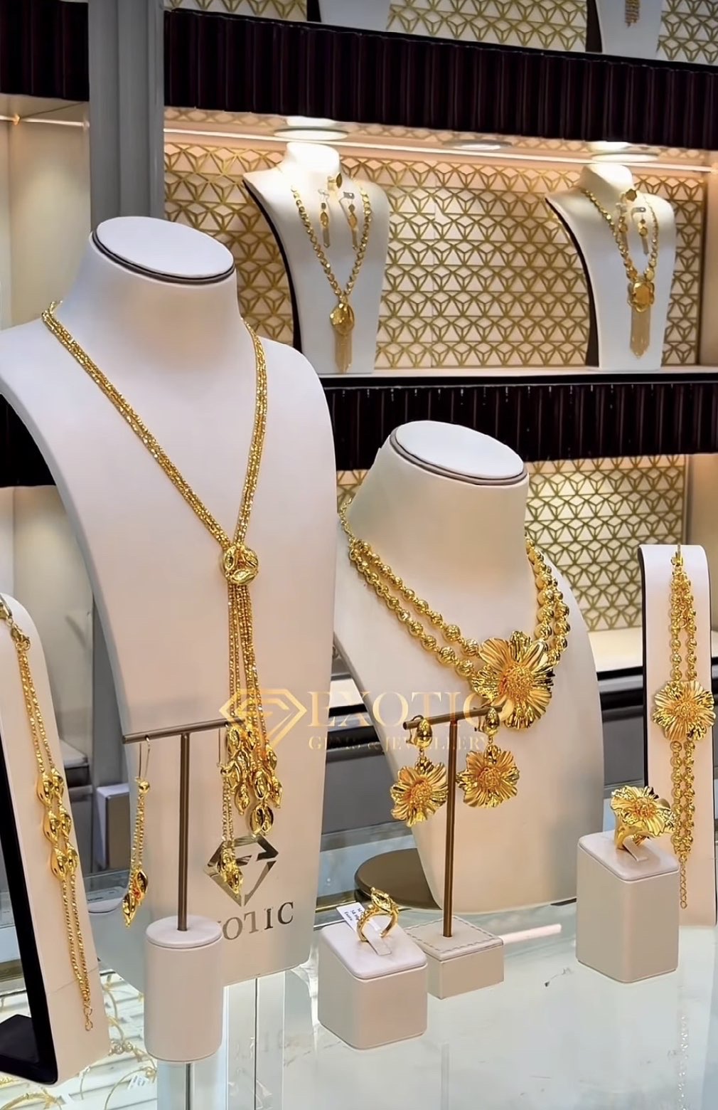 Gold necklaces, earrings and rings displayed on ivory busts in a jewellery showcase