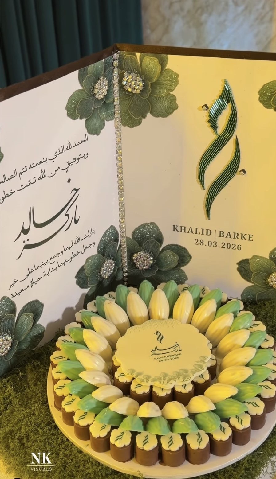 Engagement display with Arabic calligraphy card and a tray of green and gold chocolates